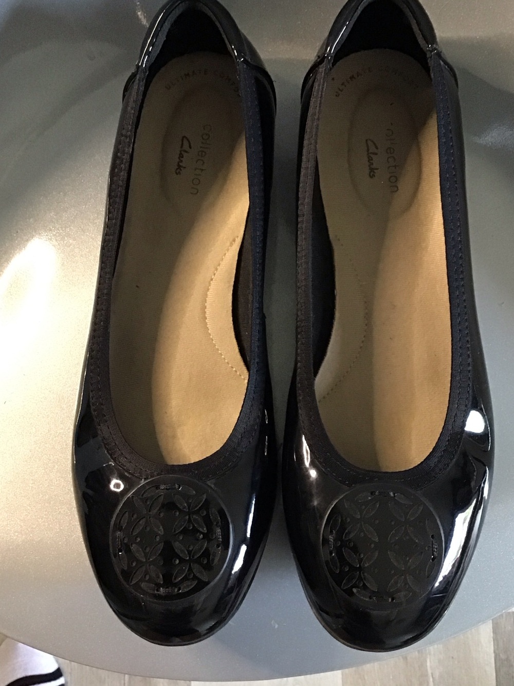 Clarks Black Patent Round-Toe Ballet Flats with Decorative Medallion